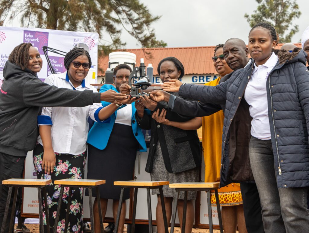 ENAF and SEPU staff hand over the mobile laboratory at Saba Saba Primary School
