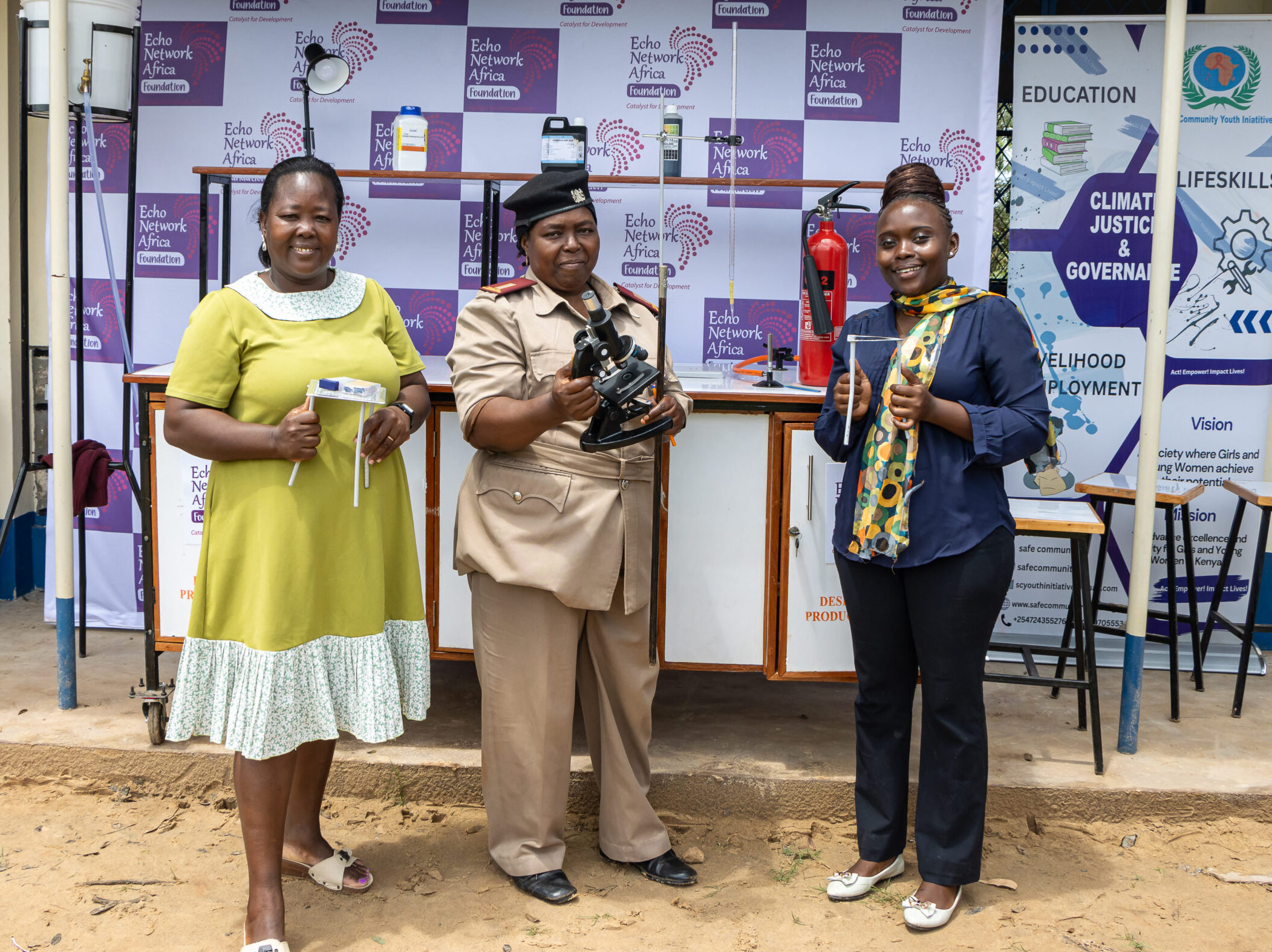Headteacher, Doris Jeza, Senior Assistant Chief, Halima Hammad, and Science Teacher, Caroline Kache pose for a photo after the handover